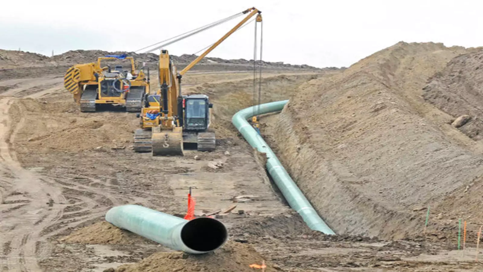 Workers laying pipelines as part of the Barauni-to-Guwahati gas pipeline project, showcasing progress in infrastructure.