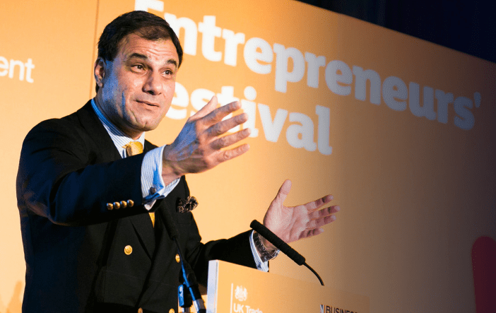 Lord Karan Bilimoria delivering a speech at an international business event.